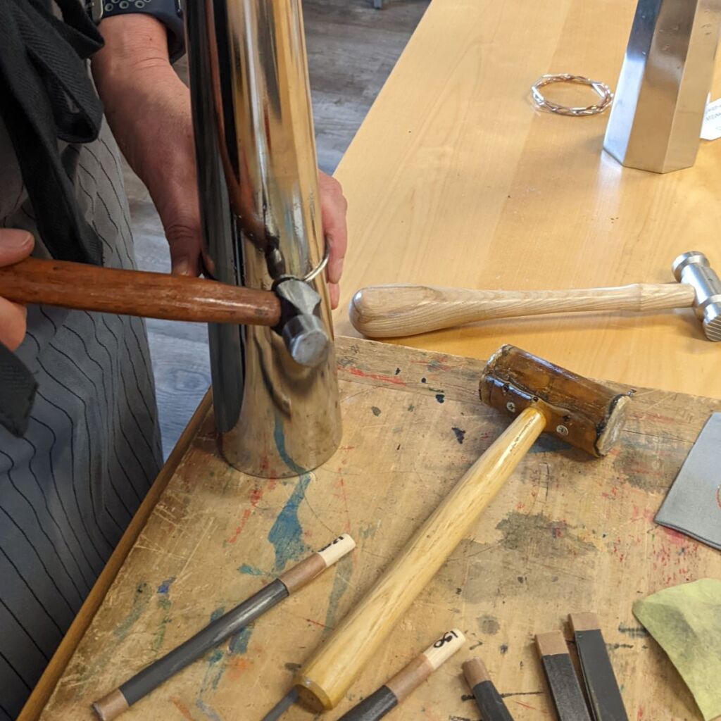 using hammers to make a bangle in one of my jewellery making workshops