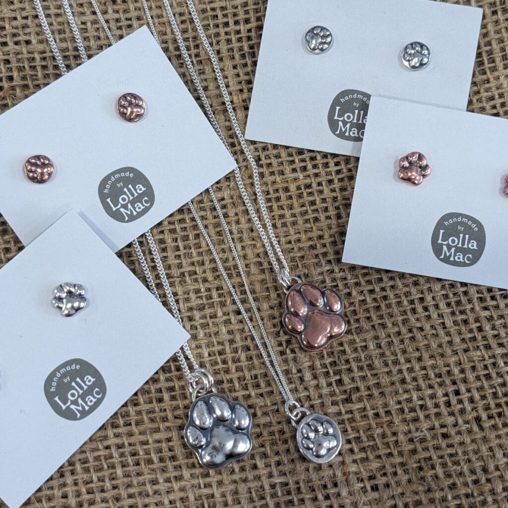 paw print pendants and earrings in silver and copper
