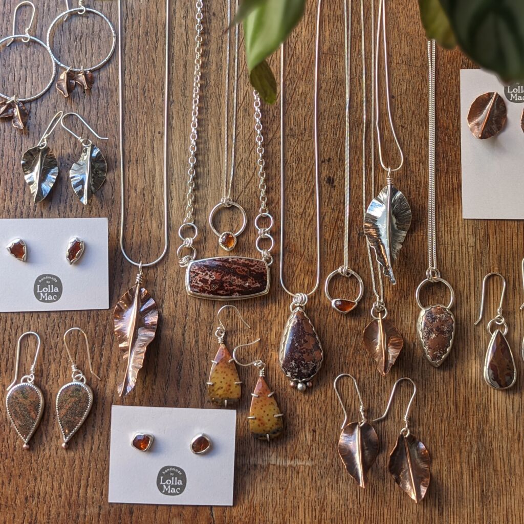 a collection of leaf shaped pendants and earrings inspired by autumn