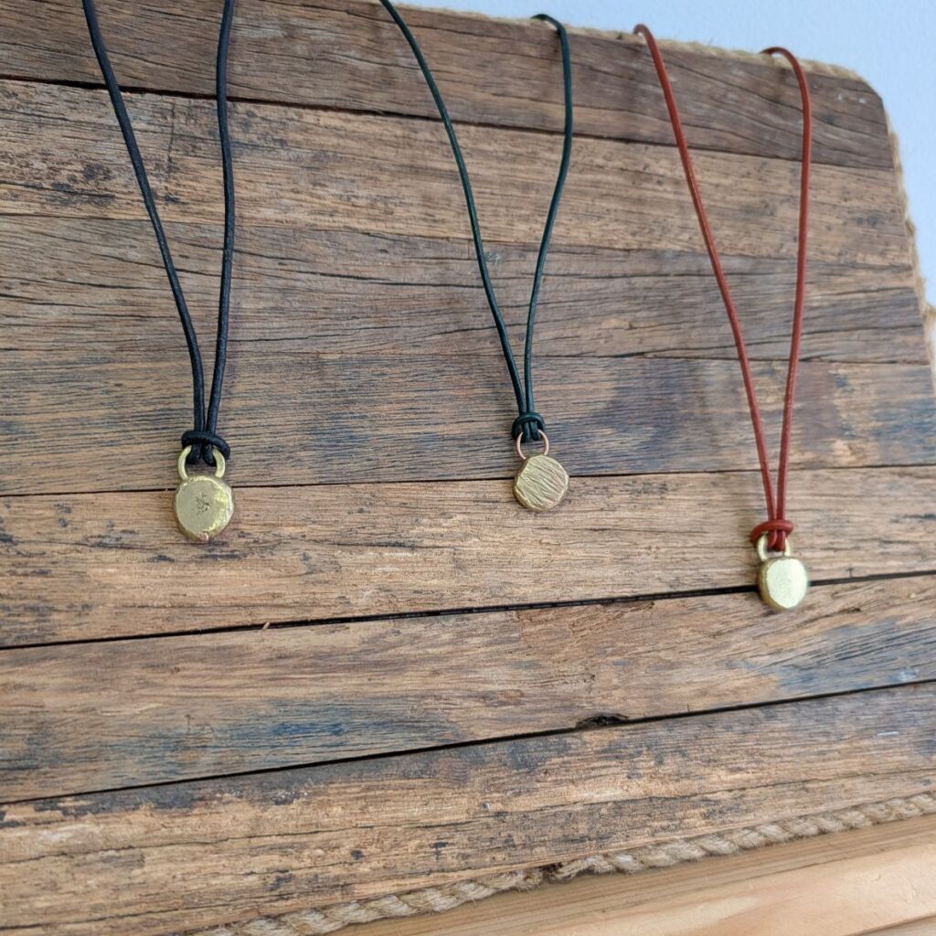 rustic reclaimed brass pendants on leather cords